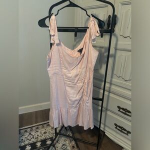 Pale pink linen mini dress with bow straps
